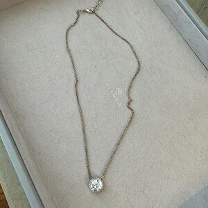 Costume jewelry diamond solitaire necklace with gold casing and chain